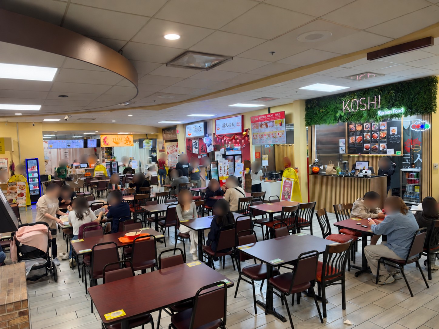 Interior view of the Dayou Market food court, with diners and food stalls.